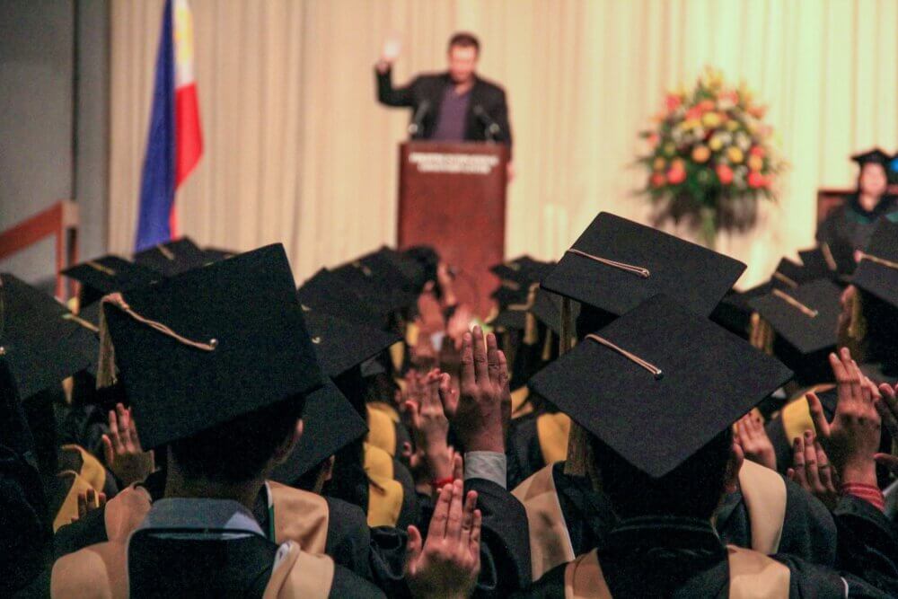 Man speaking at podium during graduation ceremony
