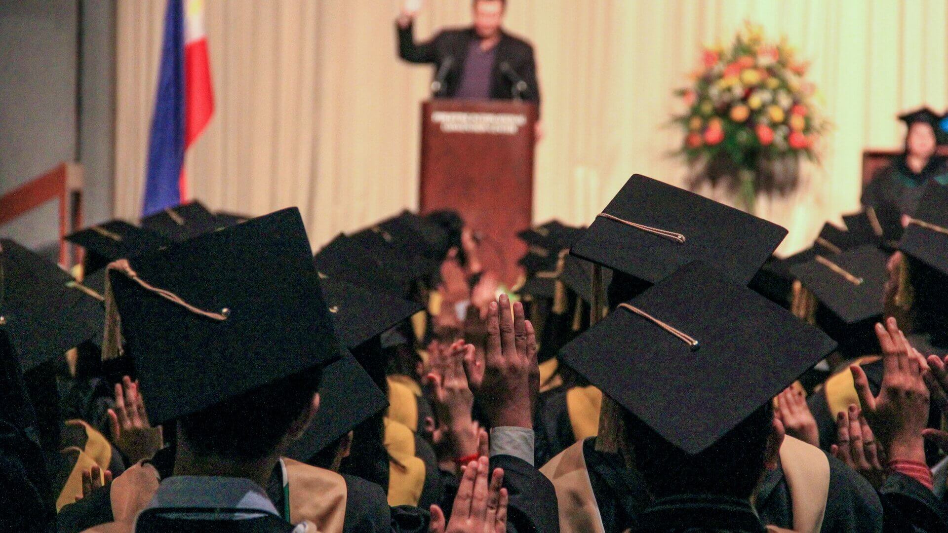 Man speaking at podium during graduation ceremony