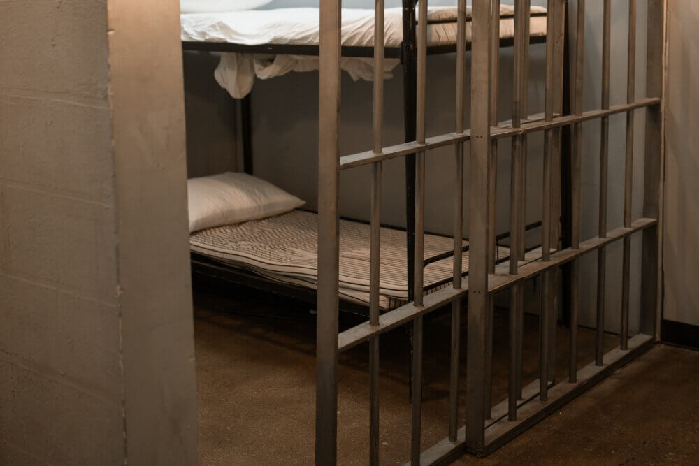 Prison cell with gate door cracked open