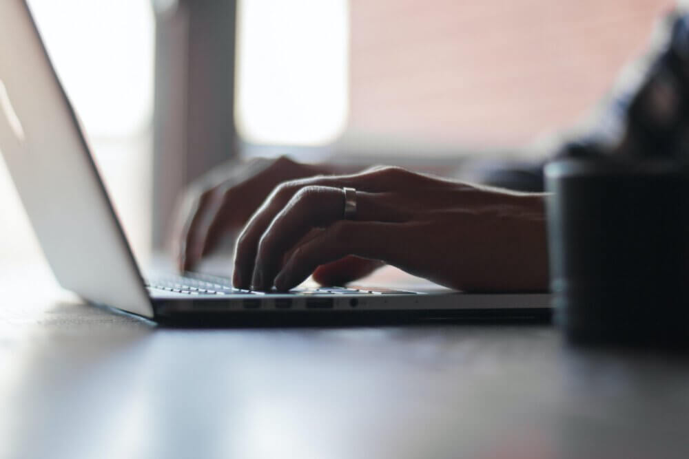 Man typing on keyboard