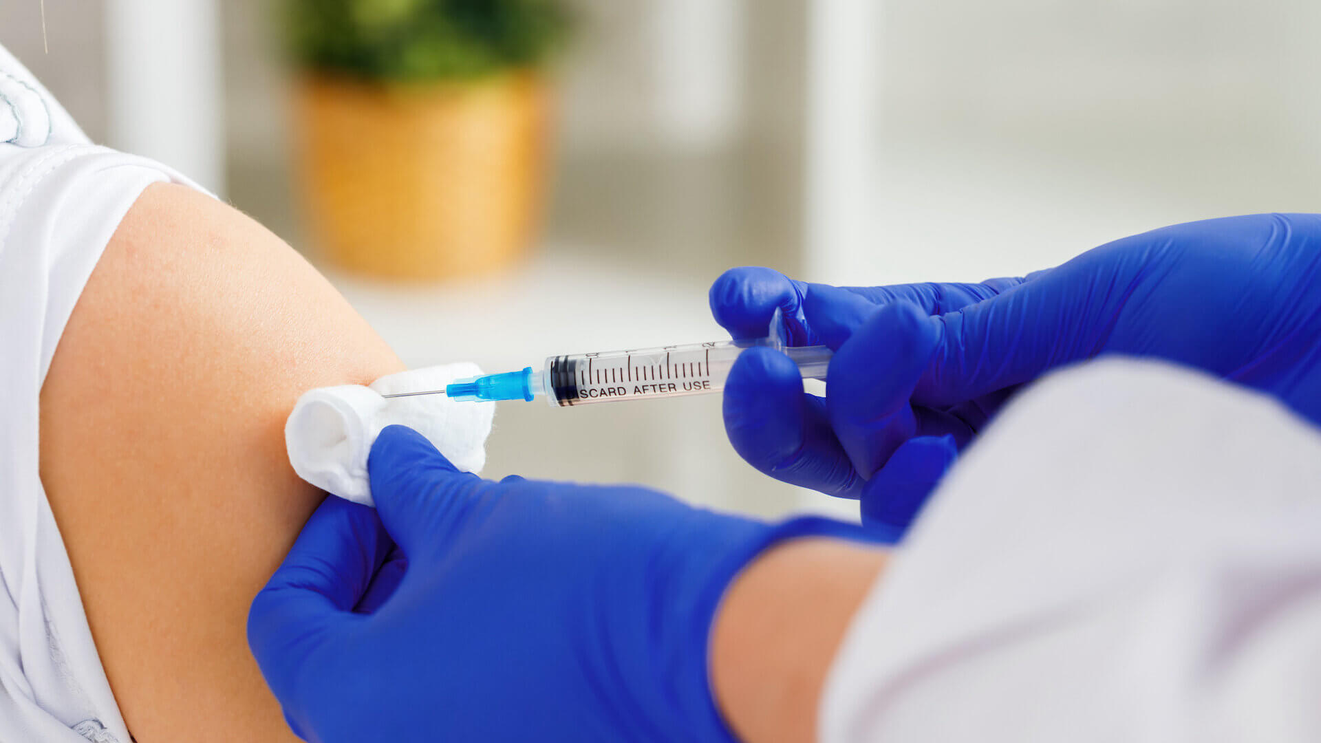 Doctor injecting vaccine into human arm