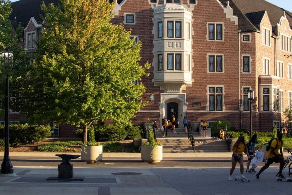 Students walking around college campus during day time
