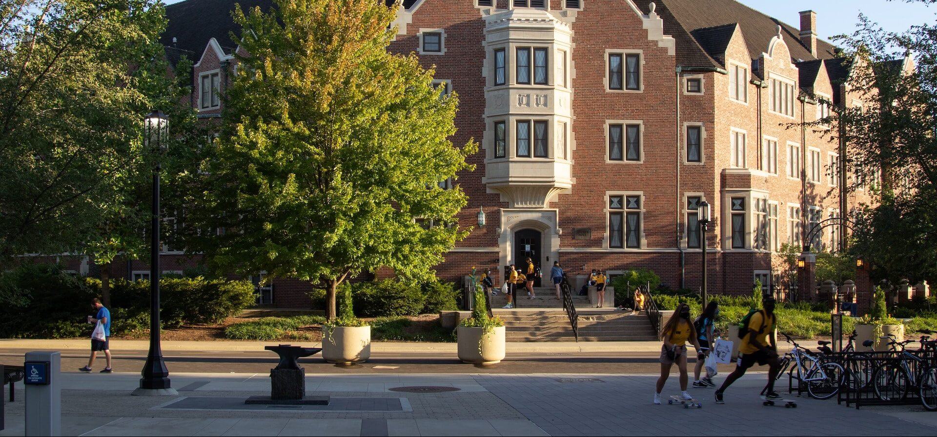 Students walking around college campus during day time