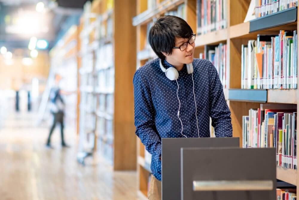 Man pushes a library cart
