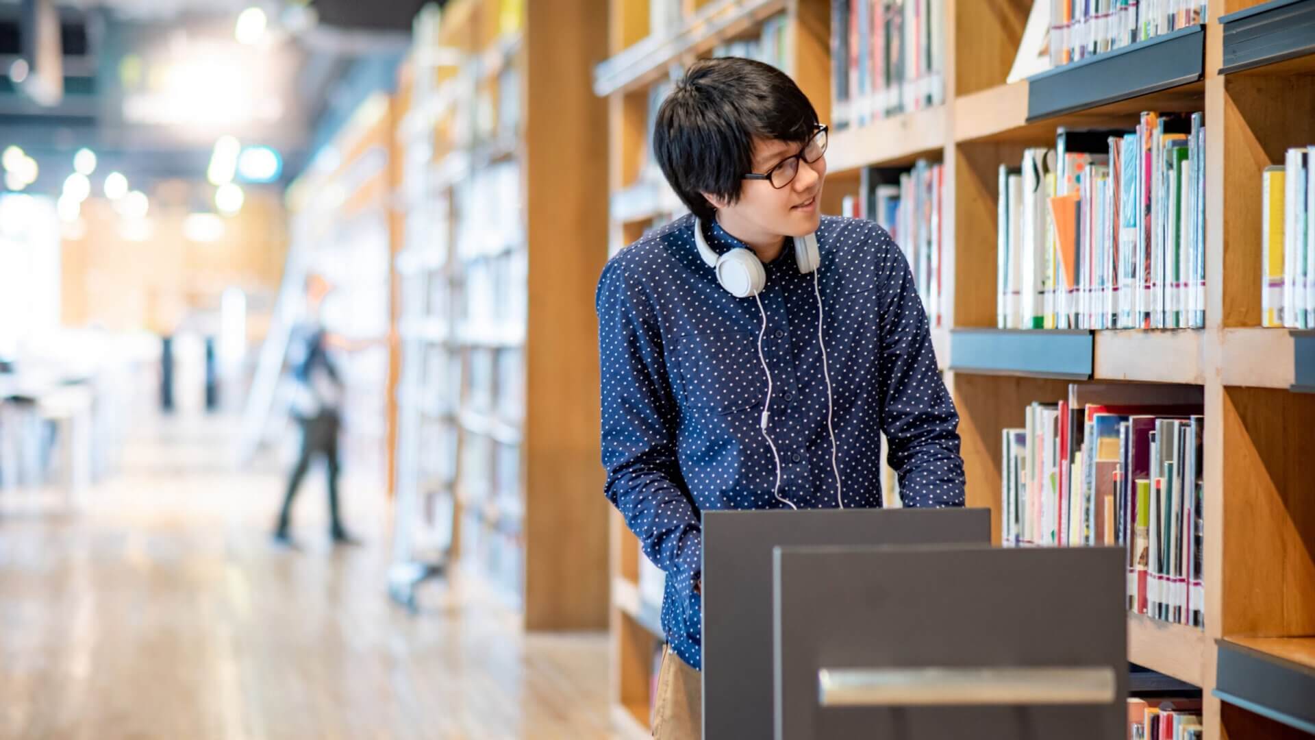 Man pushes a library cart