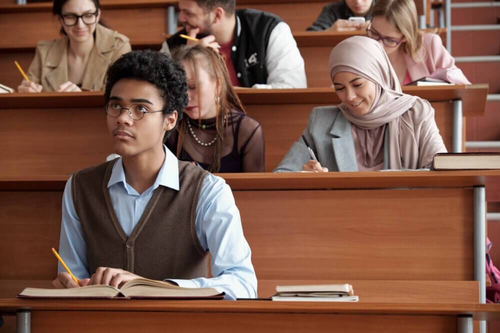 graduate students learning in a small auditorium