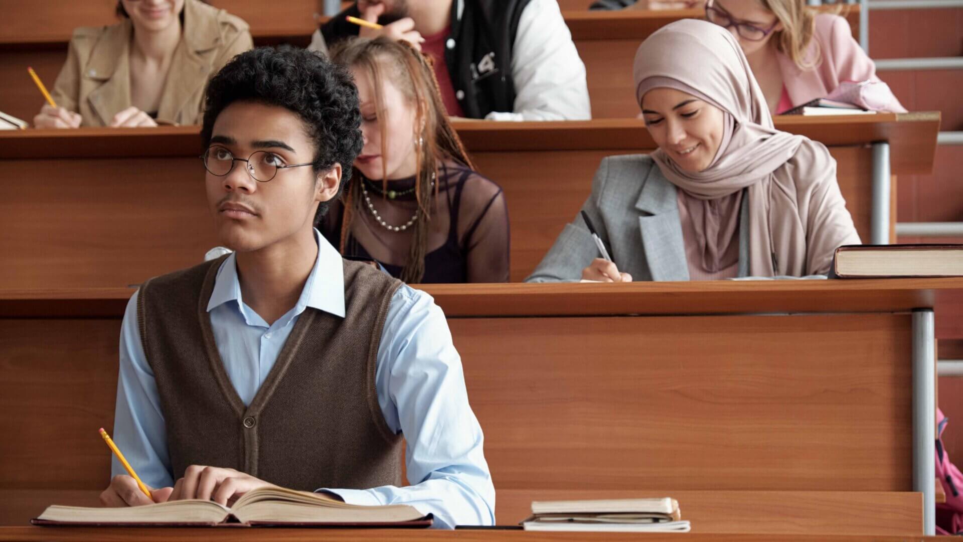 graduate students learning in a small auditorium