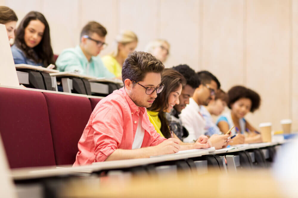 group of students with notebooks in lecture hall