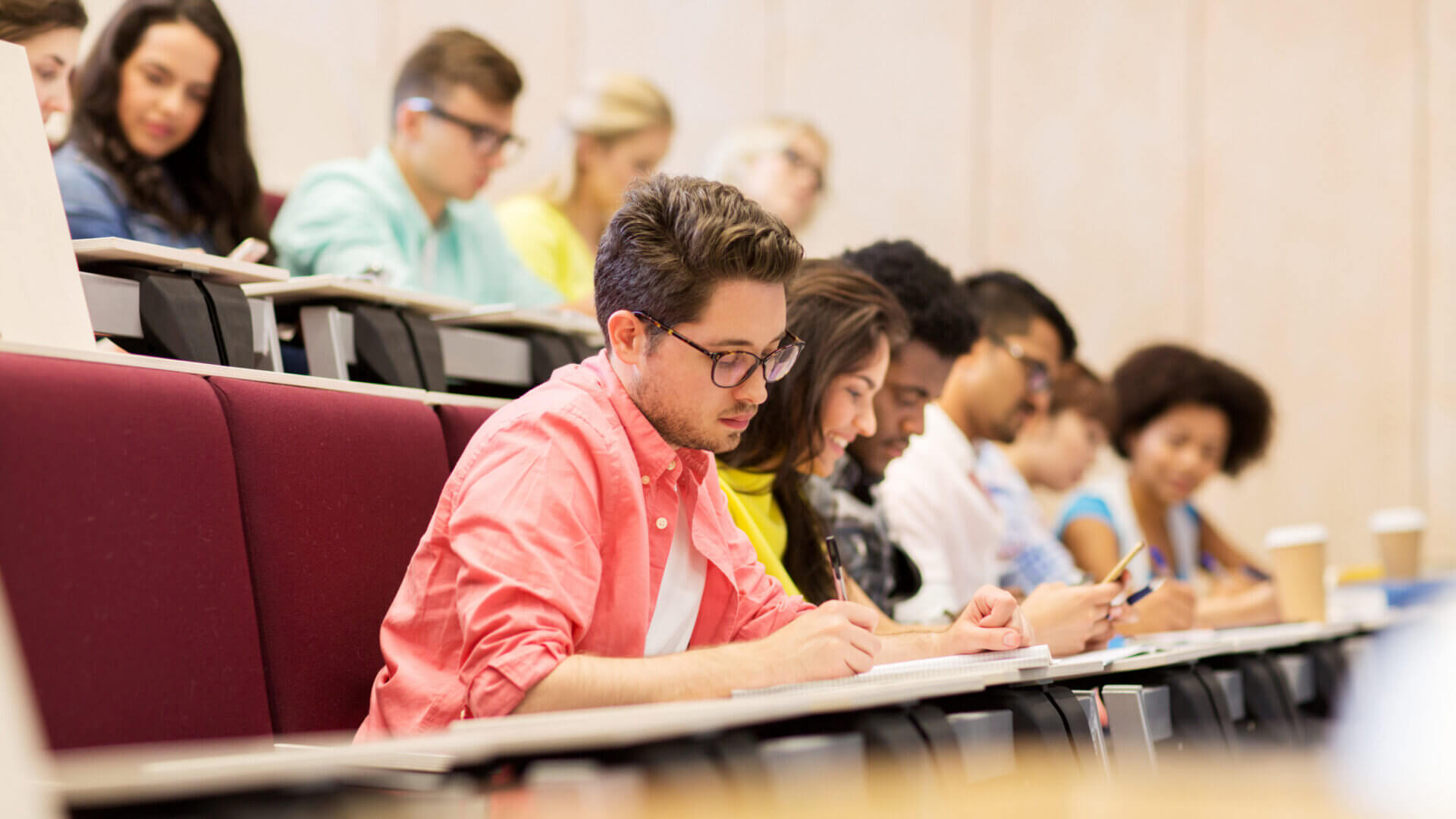 group of students with notebooks in lecture hall