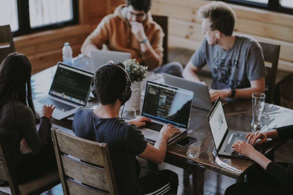 students on computers at table