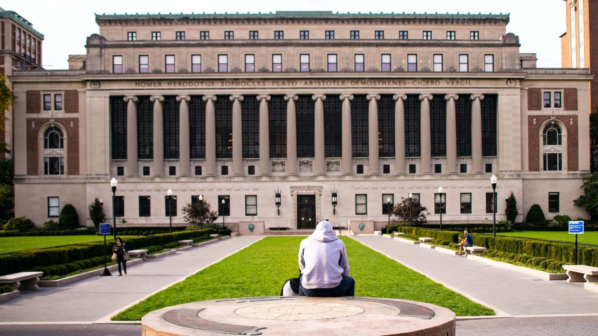 man in white dress shirt sitting at Columbia University