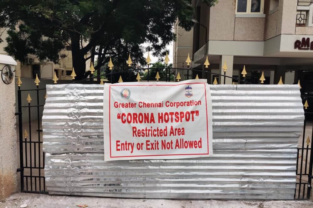 a sign posted on a gate saying to stay out due to Covid