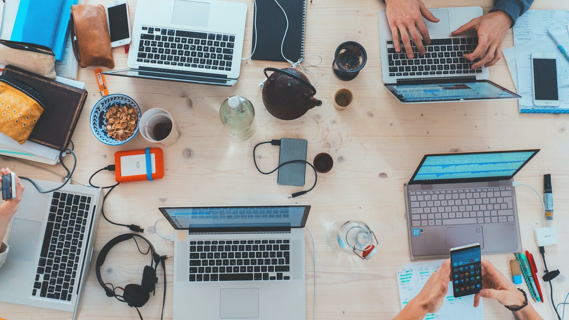 people sitting down at desk with computers