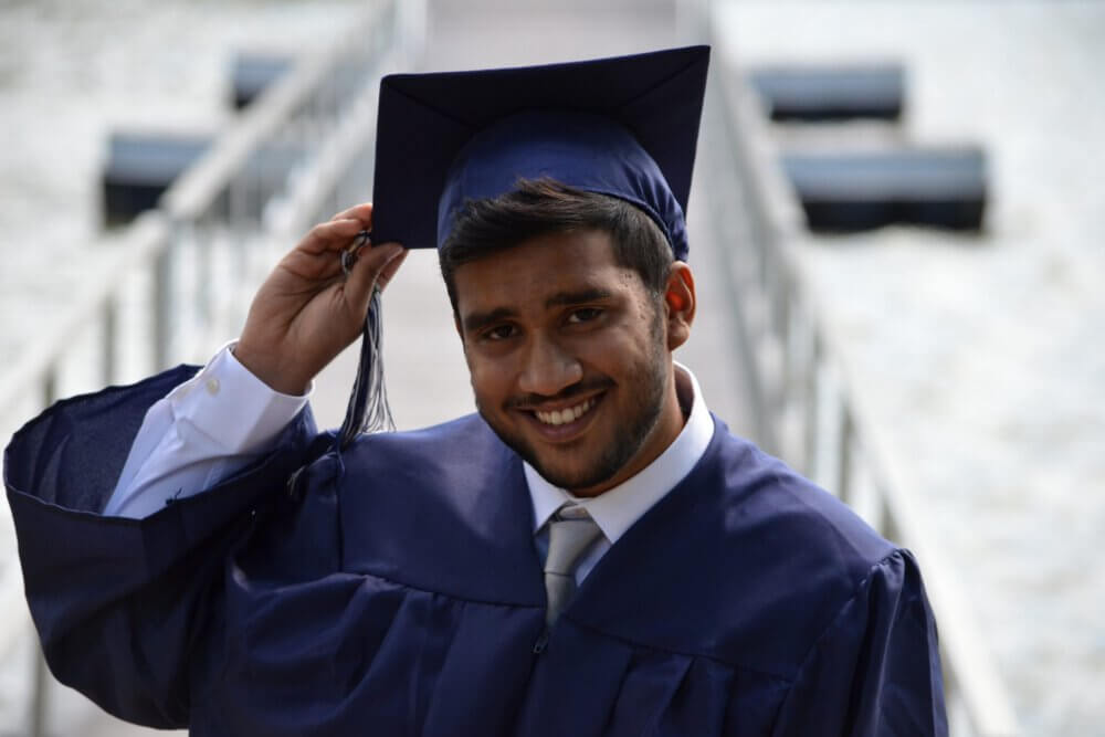 a young man in a cap and gown