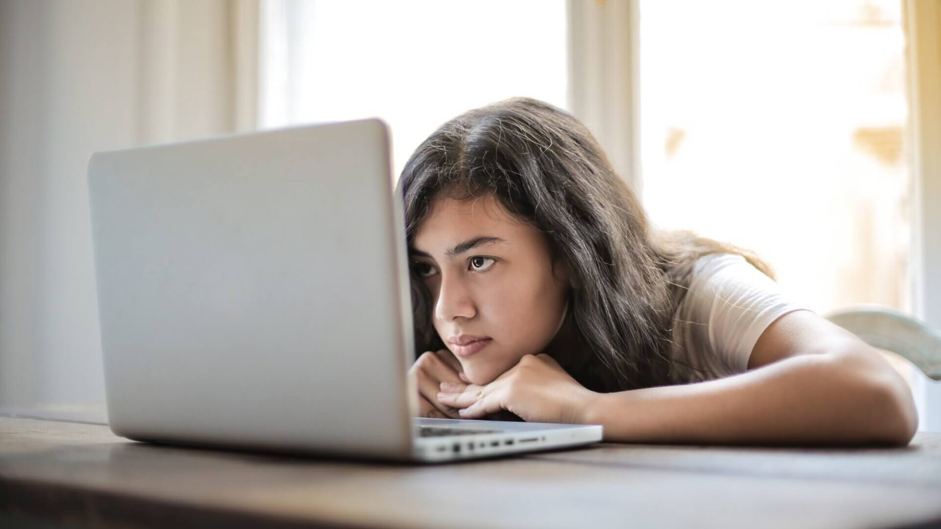 Young woman looking into computer screen