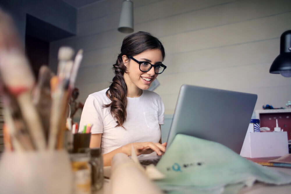 Young woman smiling at her computer