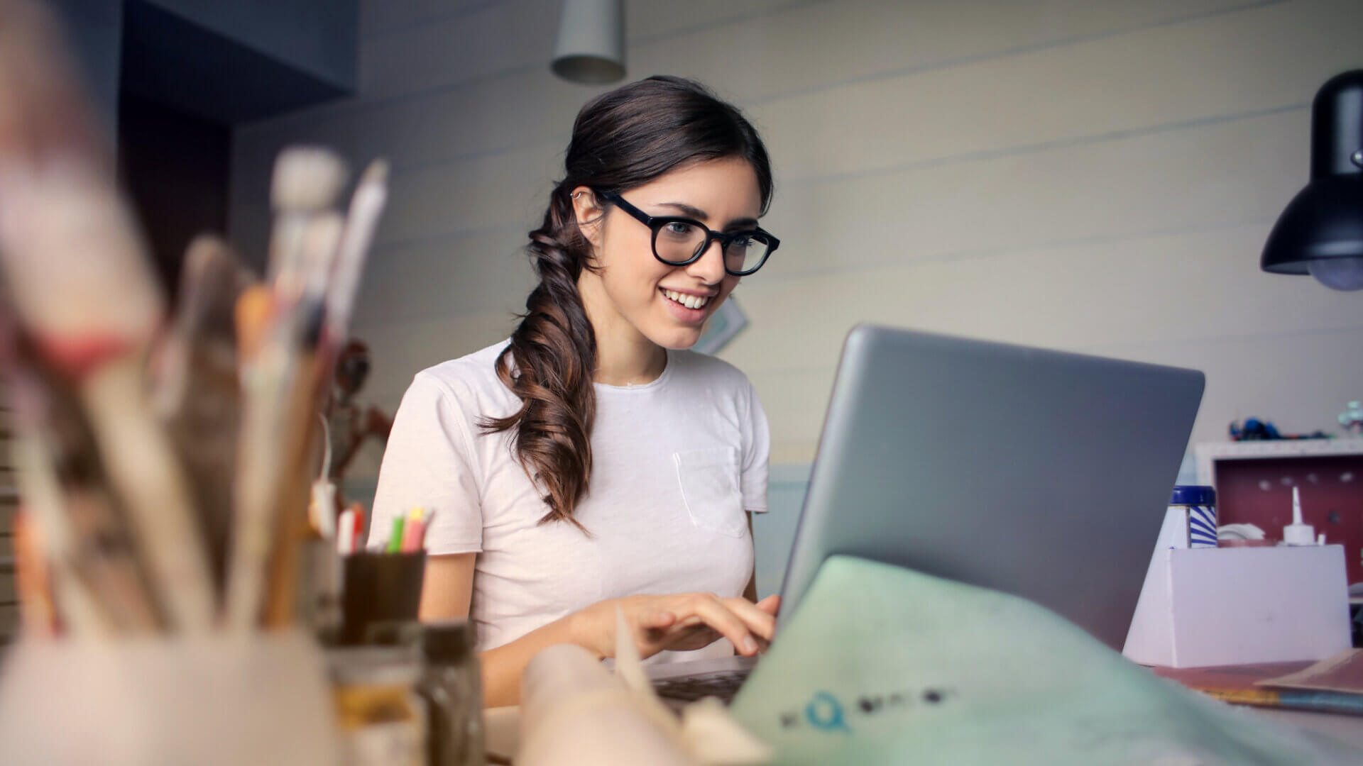 Young woman smiling at her computer