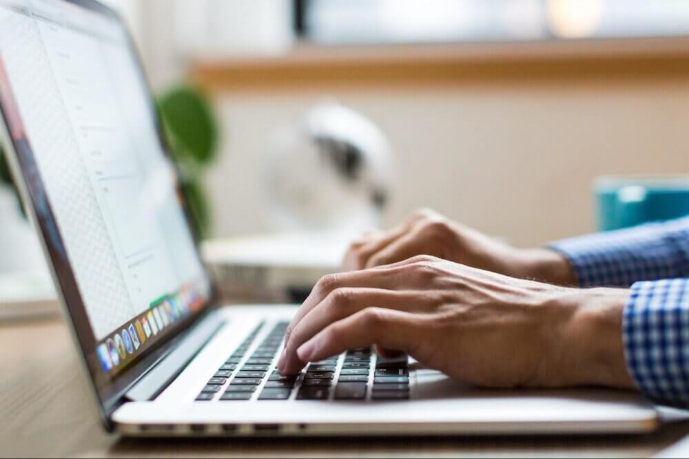Man typing on Macbook