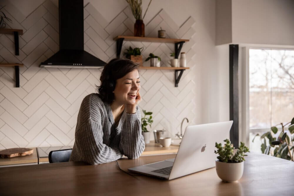 Woman watching something on computer and laughing