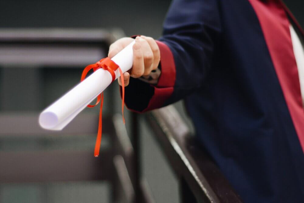 person handing over diploma
