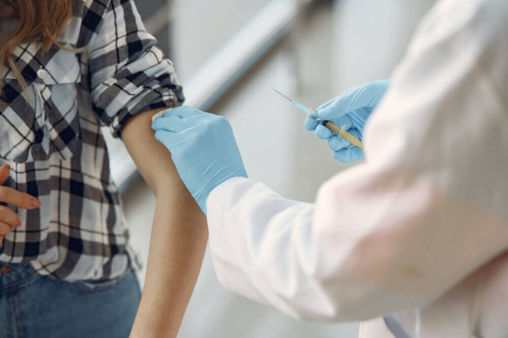 an arm being prepared for a vaccination jab