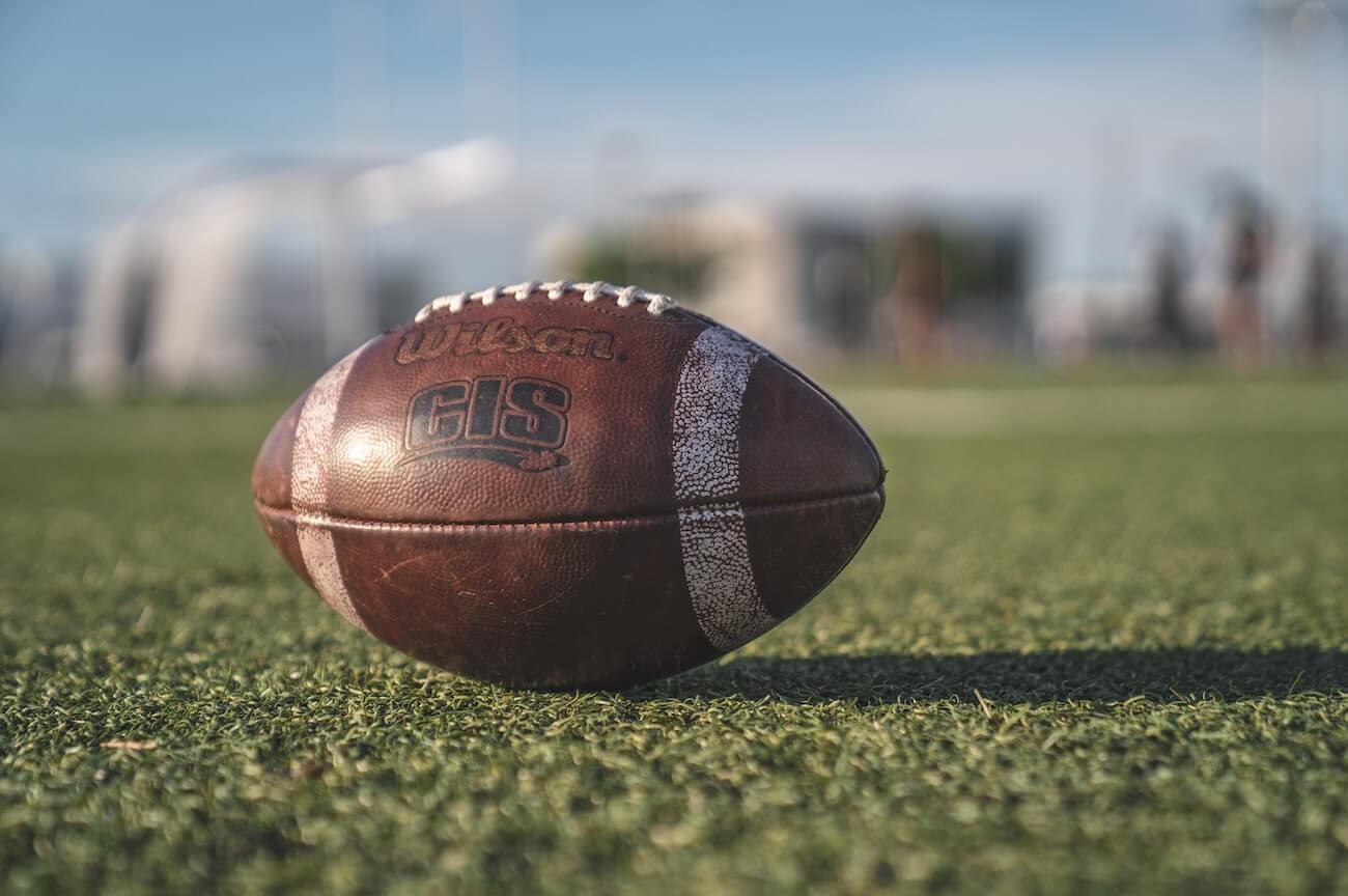 Football resting on grass with blurred background