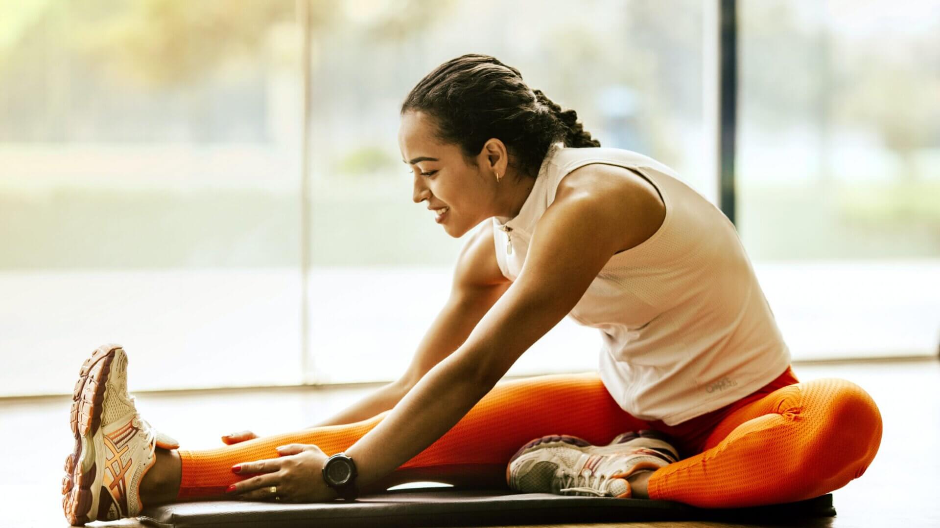 Woman stretching on floor mat