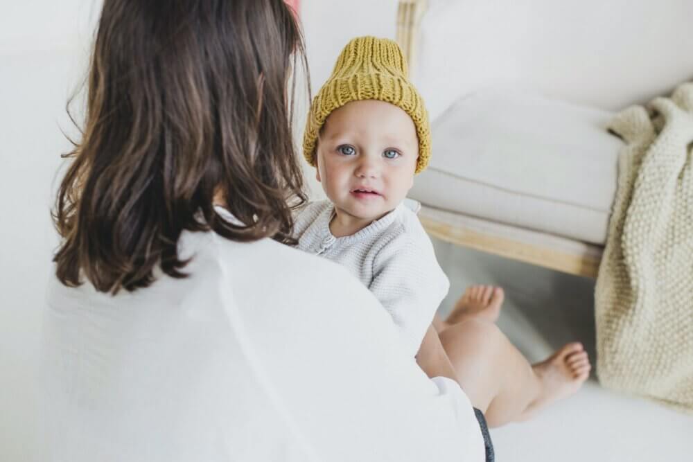 a baby in a yellow knit cap