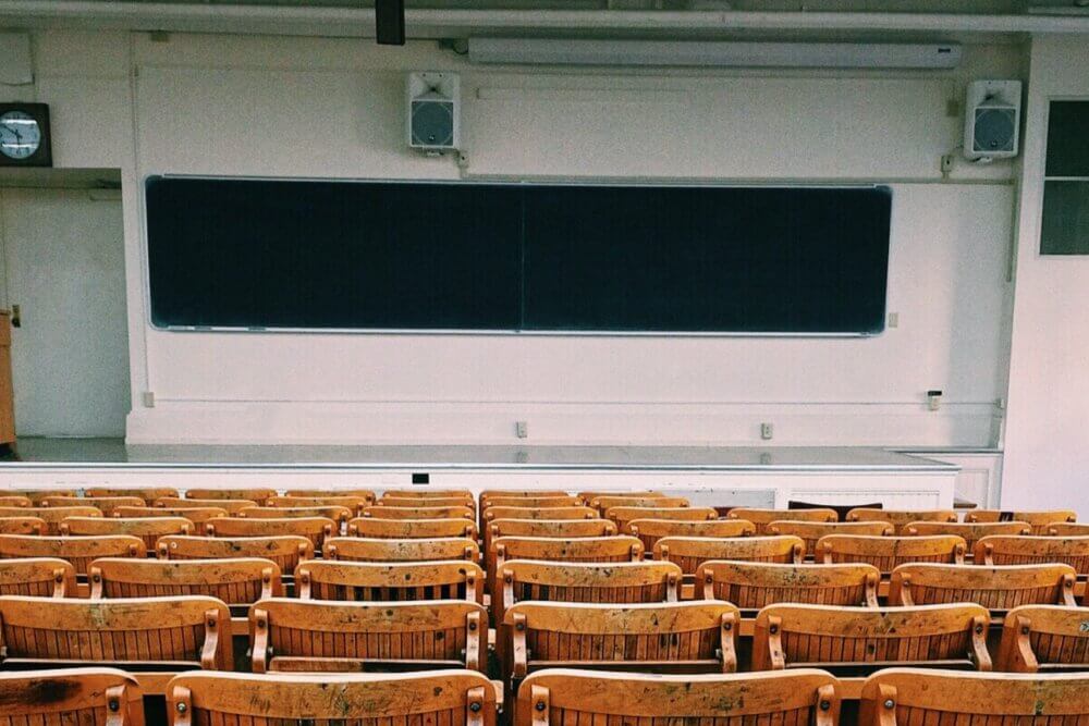 Black and wooden chairs inside empty classroom