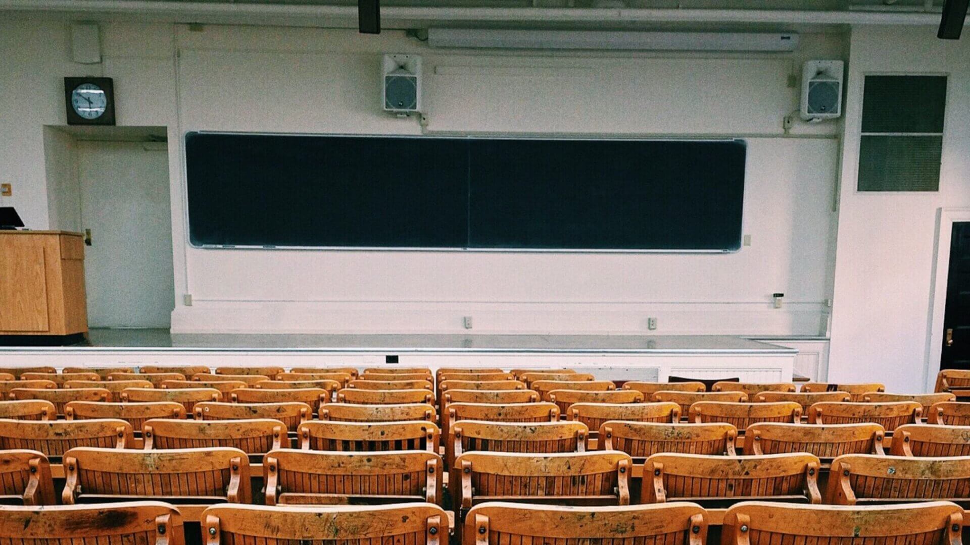 Black and wooden chairs inside empty classroom