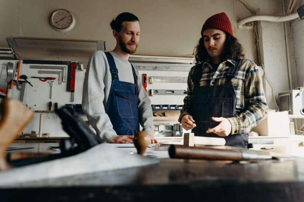 Two men working together in a workshop