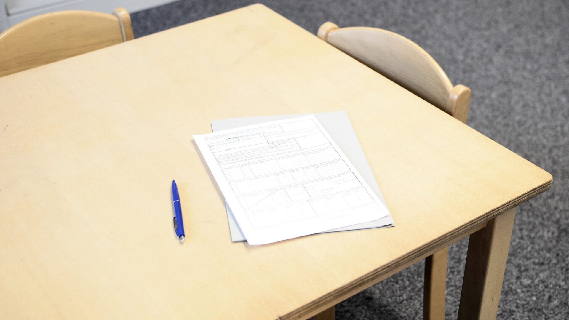 an application and pen on a desk