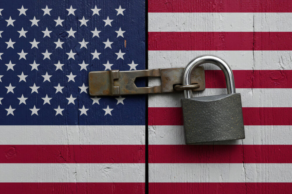 American flag painted door with a padlock closing it shut.